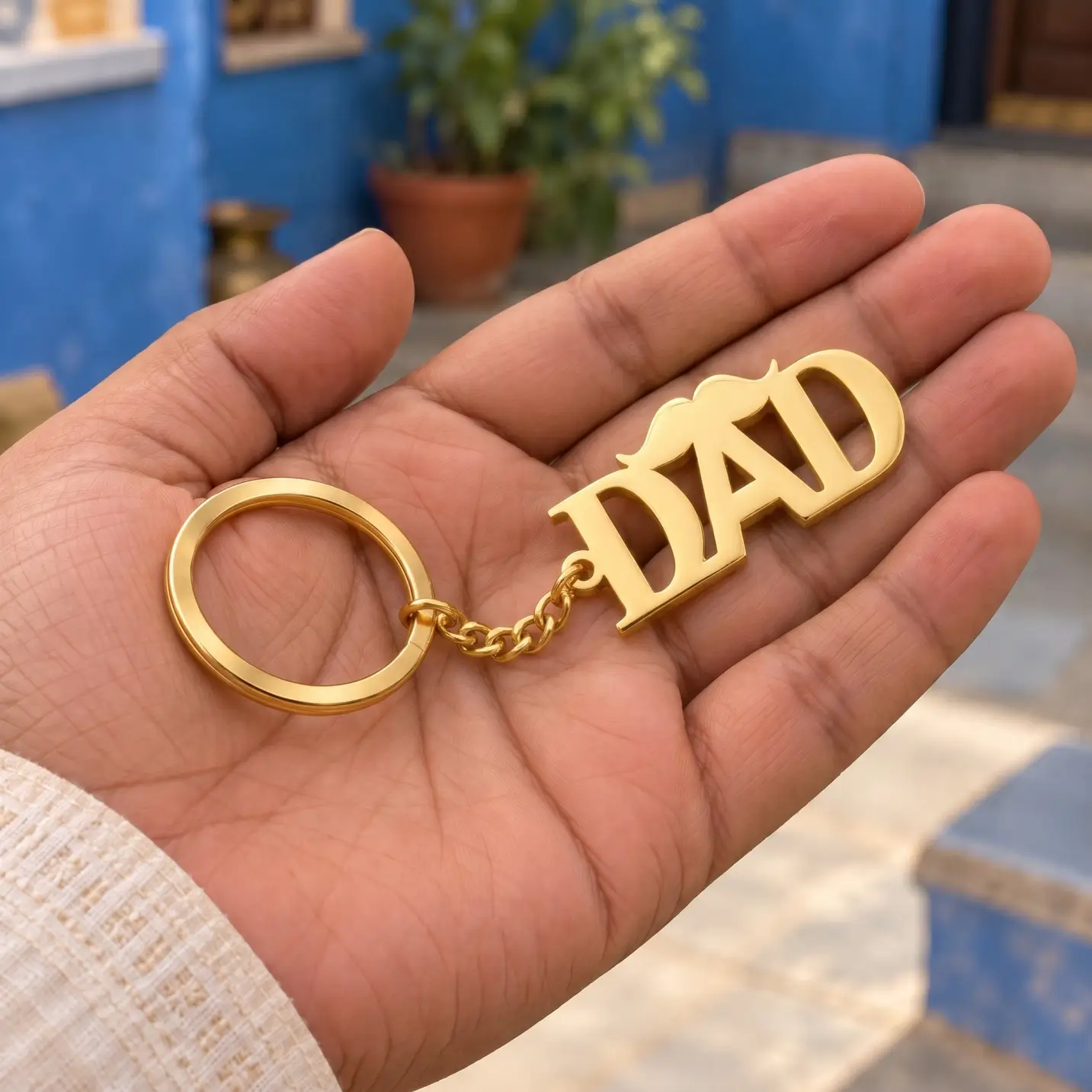 DAD Letter Keychain for Father’s Day - Handheld View DAD Letter Keychain for Father’s Day in a golden finish, held in a hand