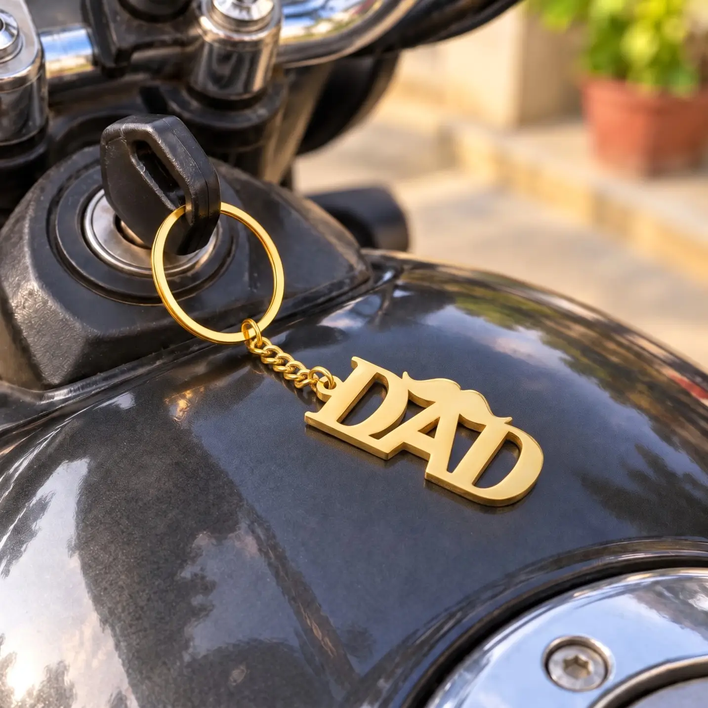 DAD Letter Keychain for Father’s Day - Motorcycle Key View DAD Letter Keychain for Father’s Day in a golden finish, attached to a motorcycle ignition key
