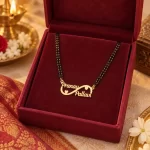 Double Heart Infinity Couple Name Necklace with a black-beaded chain in a red display box
