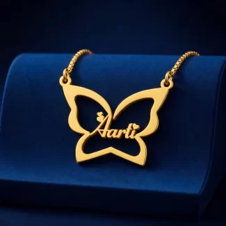Gold-tone large butterfly outline name necklace on a navy velvet display