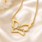 Gold-tone large butterfly outline name necklace on ivory satin