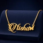 Gold-tone script name necklace with a small butterfly on a navy velvet display