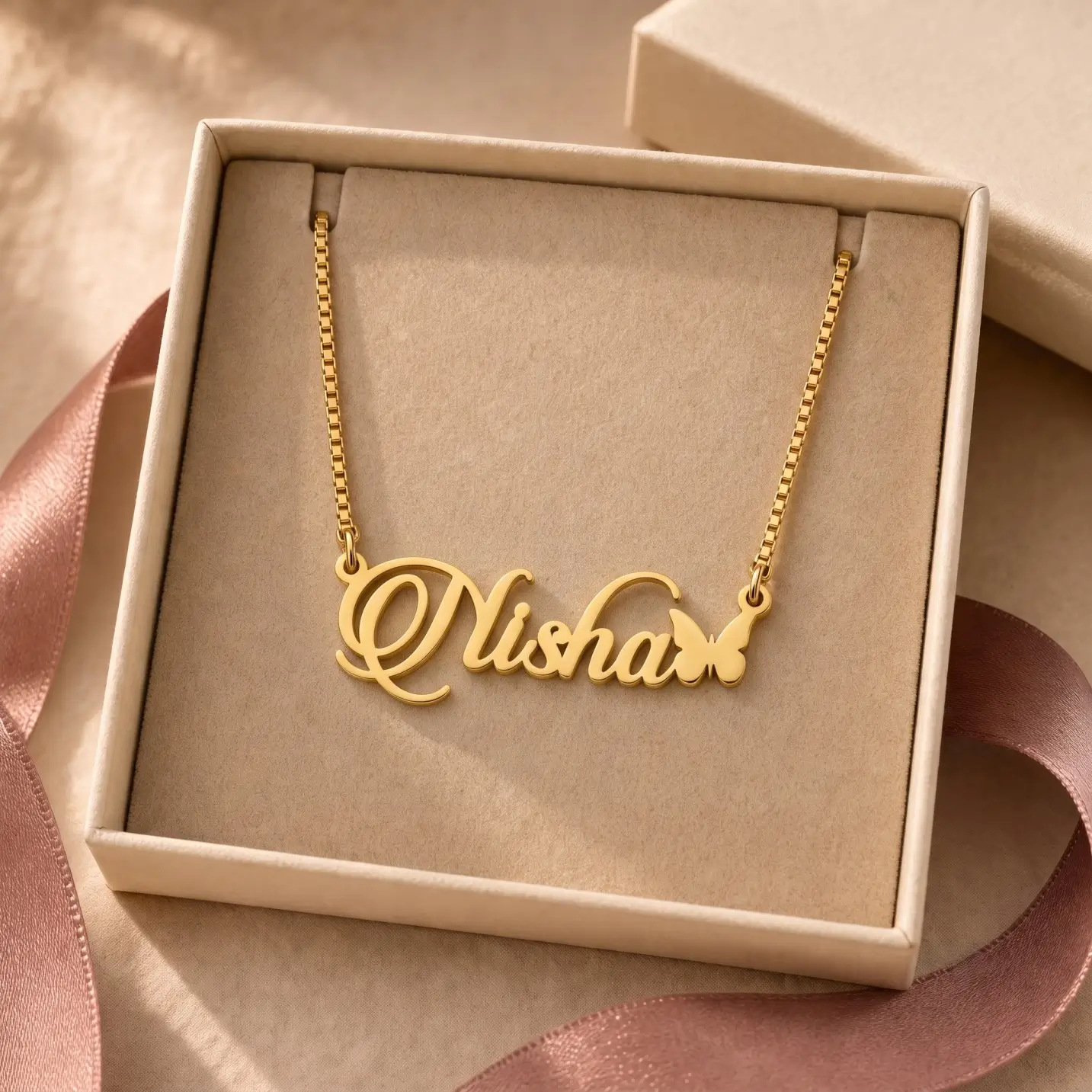 Personalized Butterfly Name Necklace – Jewellery Box Gold-tone script name necklace with a small butterfly displayed in an open beige jewellery box