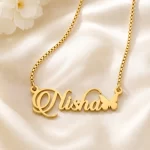 Gold-tone script name necklace with a small butterfly on ivory satin