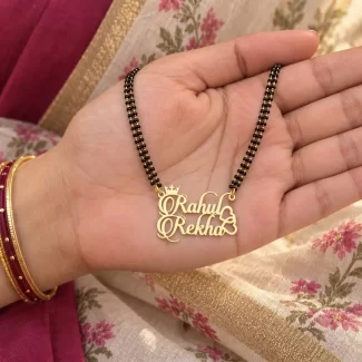 Stylish Couple Name Necklace with a black-beaded chain held in a hand