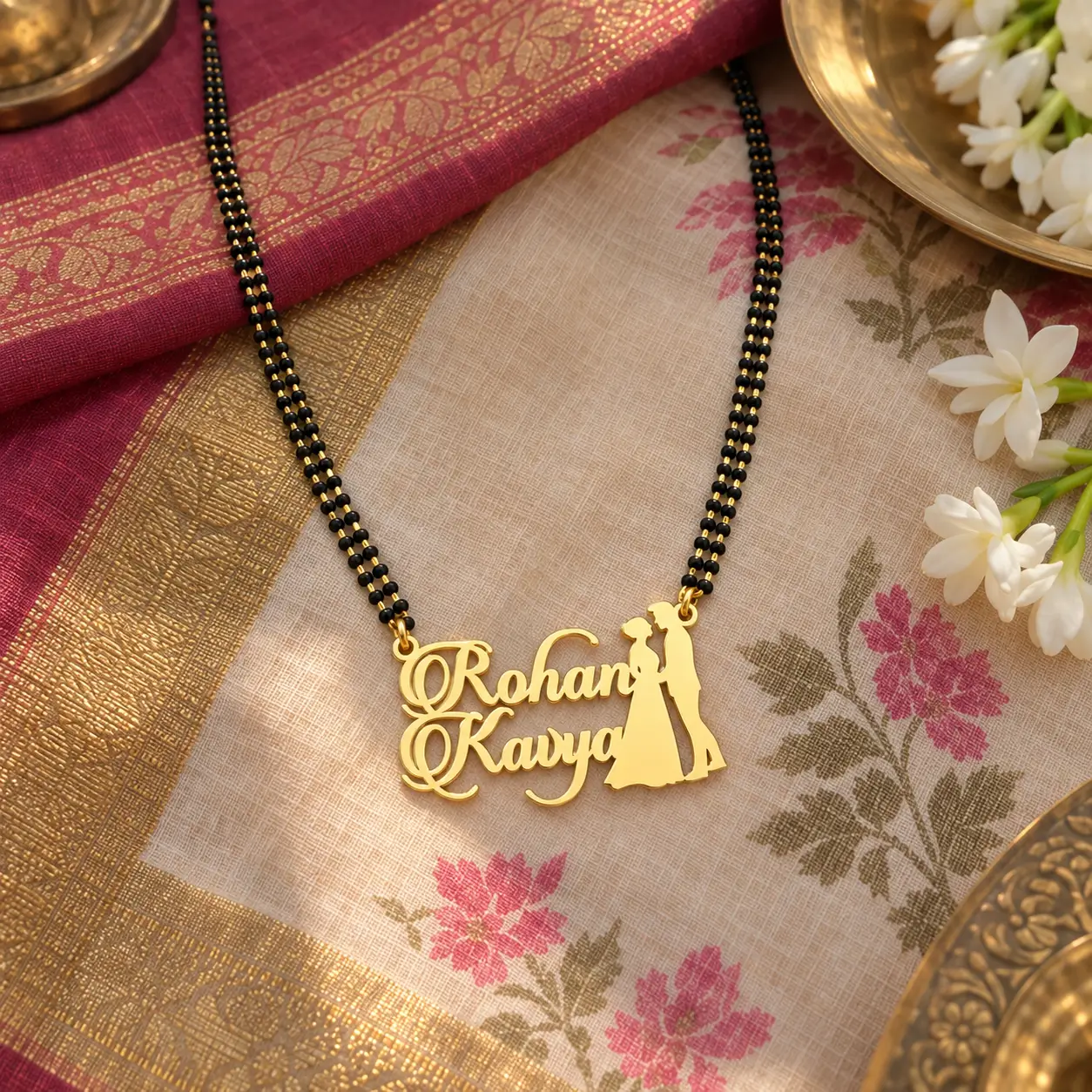 Couple Design Name Necklace – With a black-beaded chain on floral fabric Couple Design Name Necklace with a black-beaded chain on floral fabric