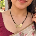 Romantic Couple Design Name Necklace with a black-beaded chain worn with a sari