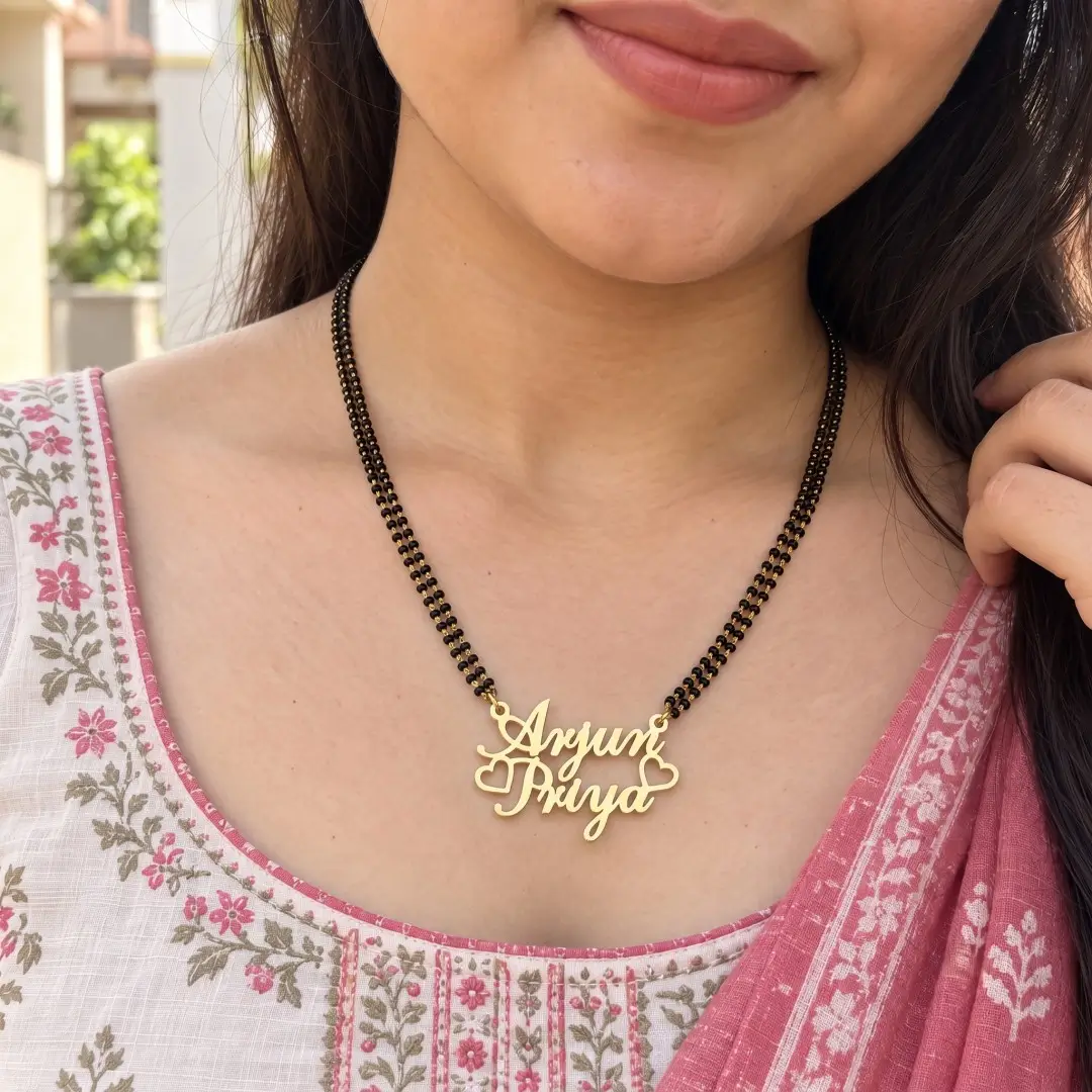 Crown and Heart Couple Name Necklace – With a black-beaded chain shown on a model Crown and Heart Couple Name Necklace with a black-beaded chain shown on a model