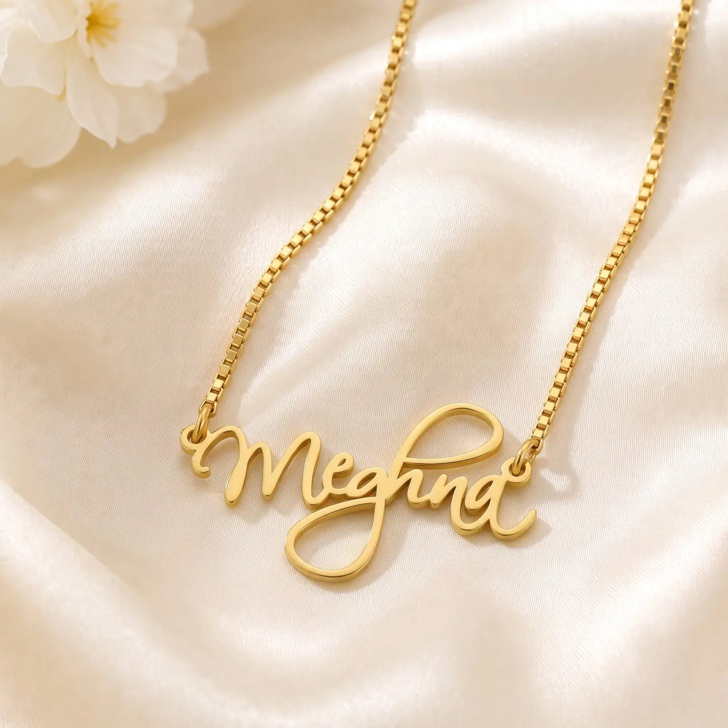 Curved Letter Name Necklace – Satin Detail Gold-tone curved cursive name necklace on ivory satin