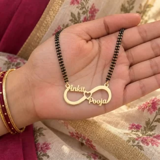 Classic Infinity Couple Name Necklace with a black-beaded chain held in a hand
