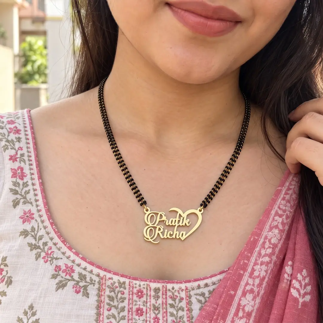Half Heart Couple Name Necklace – With a black-beaded chain shown on a model Half Heart Couple Name Necklace with a black-beaded chain shown on a model