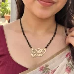 Half Heart Couple Name Necklace with a black-beaded chain worn with a sari