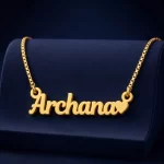 Gold-tone simple name pendant with a small heart on a navy velvet display