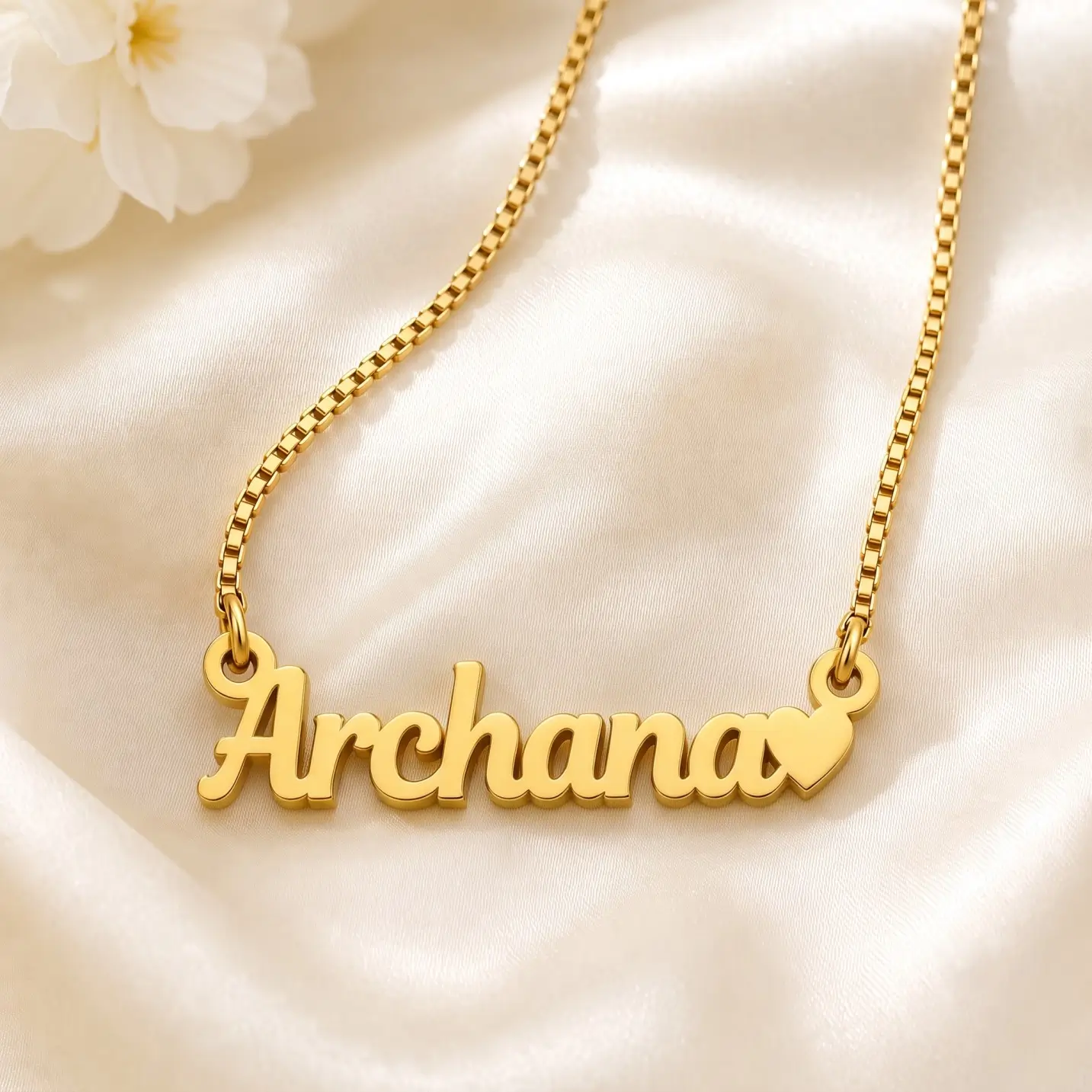 Simple Heart Name Pendant – Satin Detail Gold-tone simple name pendant with a small heart on ivory satin
