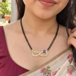 Blue Evil Eye Infinity Couple Name Necklace with a black-beaded chain worn with a sari