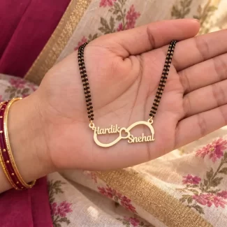 Infinity Love Couple Name Necklace with a black-beaded chain held in a hand