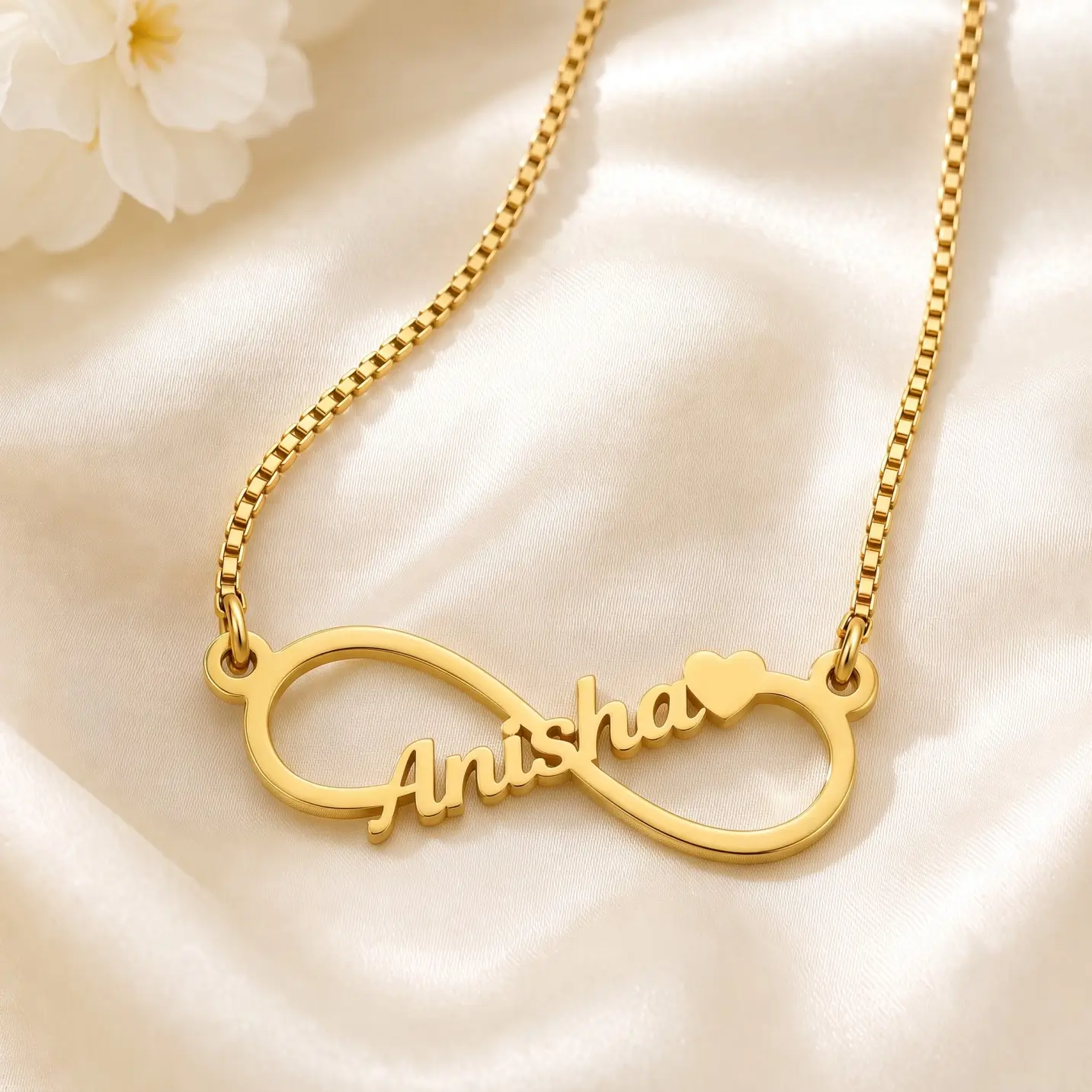 Personalized Infinity Name Necklace – Satin Detail Gold-tone infinity outline name necklace on ivory satin