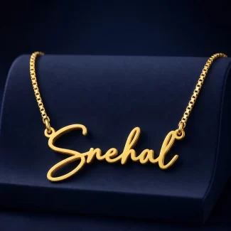 Gold-tone signature script name necklace on a navy velvet display