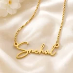 Gold-tone signature script name necklace on ivory satin