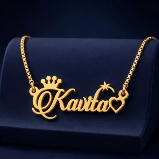 Gold-tone name necklace with crown, star and heart accents on a navy velvet display