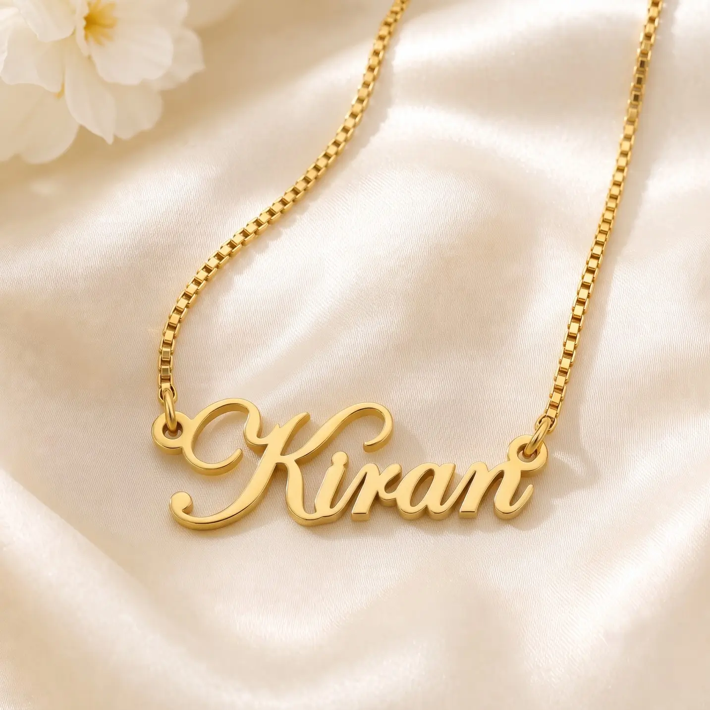 Stylish Letter Name Pendant – Satin Detail Gold-tone stylish cursive name pendant on ivory satin