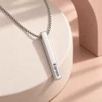 Personalized Silver Finish 3D Bar Pendant on a pink display