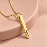 Personalized Golden 3D Bar Pendant on a pink display