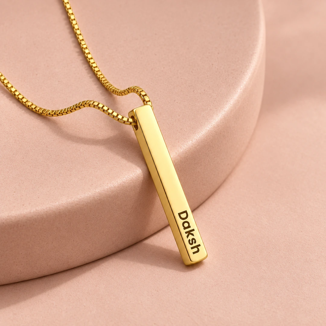 Personalized Golden 3D Bar Pendant – On a pink display Personalized Golden 3D Bar Pendant on a pink display